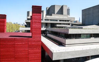 Straight angled buiding on the southbank. Bright red constrasting with blue sky